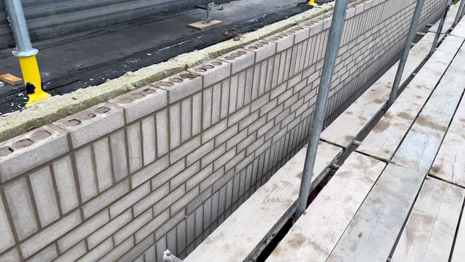 Pale brickwork with soldier-course detailing
